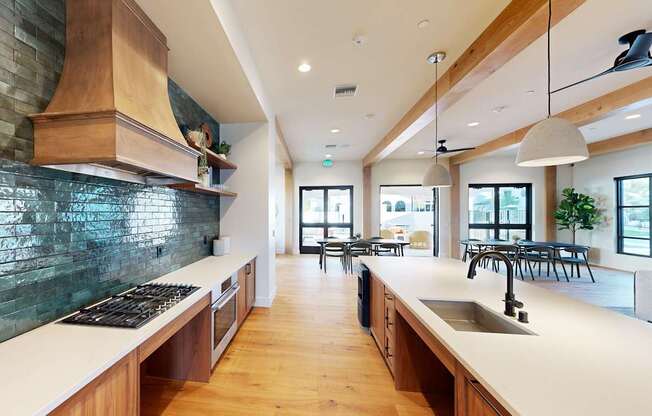 A modern kitchen with wooden cabinets and a green backsplash at The Villas at Anacapa Canyon, Camarillo, 93012
