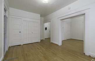 the living room and dining room with white doors and wood flooring at Clay & Tiffany, Portland, 97201