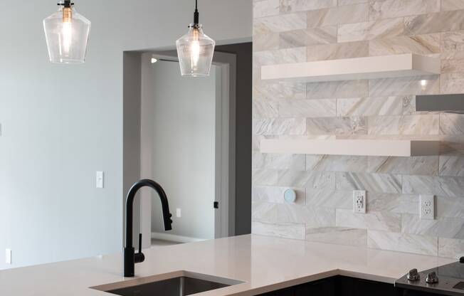 a kitchen counter with a sink and a door to a bathroom