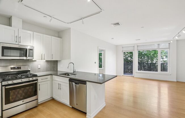 Kitchen with living room view at Park77 Apartments, Cambridge