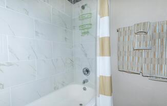 a white tub sitting next to a shower