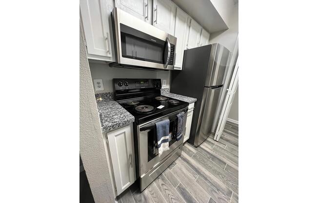 a stove top oven sitting inside of a kitchen