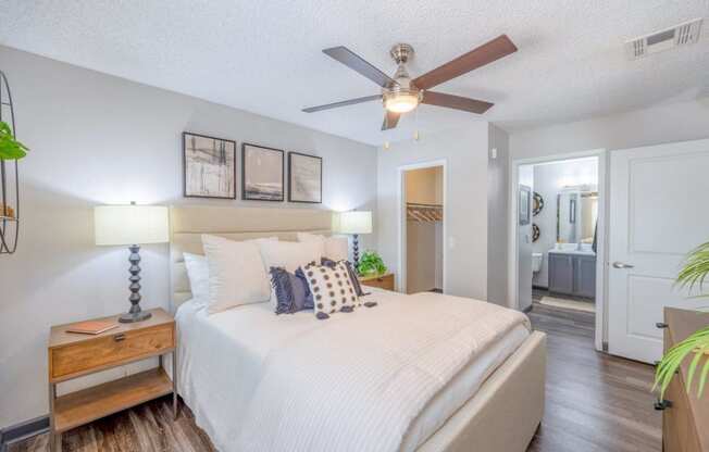 a bedroom with a large bed and a ceiling fan