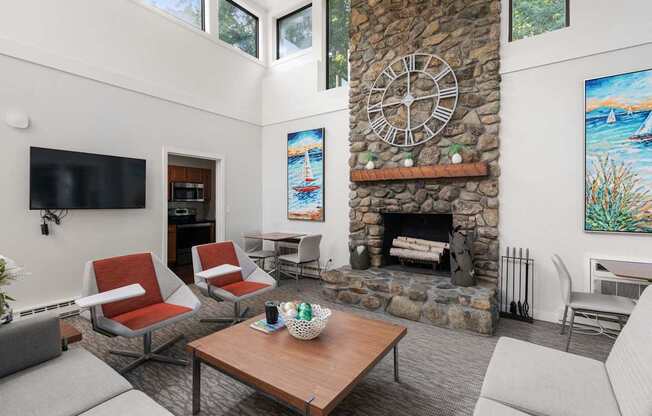 A living room with a stone fireplace and a large clock on the wall.