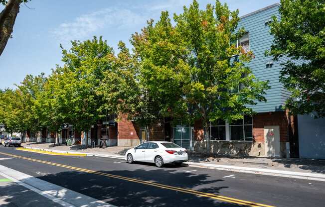 a white car parked in front of a building on a street