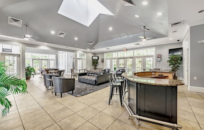 a resident clubhouse with a pool table and couches