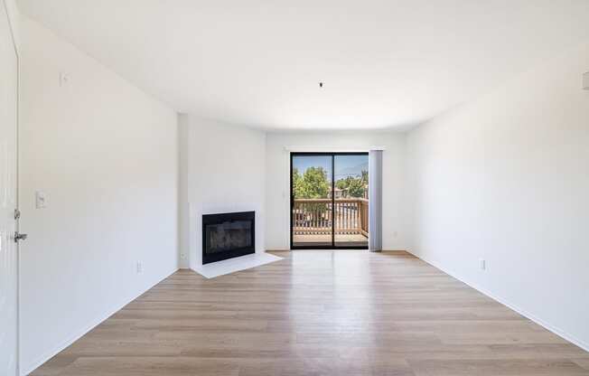 a living room with white walls and a fireplace