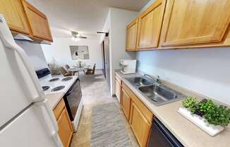 the view of a kitchen and dining room from the entrance of a home