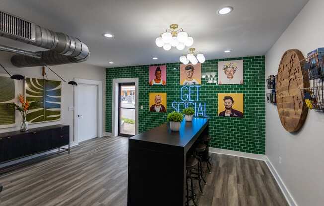 a room with green tiles and a black table and chairs