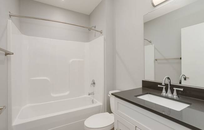 a bathroom with a sink toilet and a tub