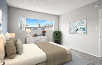 Carpeted bedroom with large window for natural light.