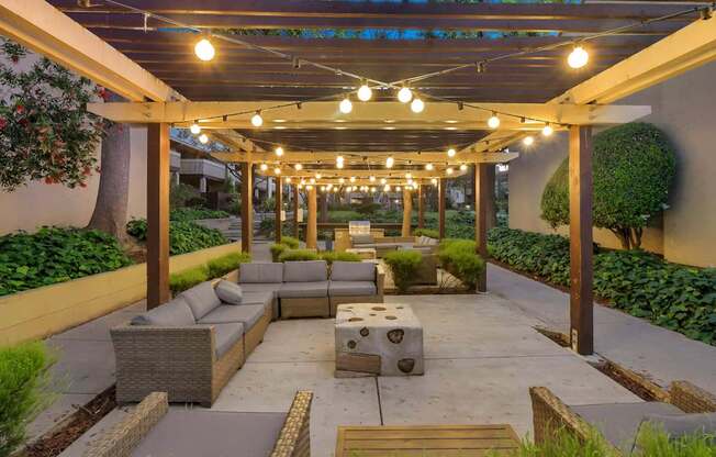 a patio with a couch and a table under a canopy at Summerwood Apartments, Santa Clara, California