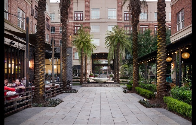 An interior open-air courtyard on the ground level of Hanover Rice Village with restaurants and retail shops.