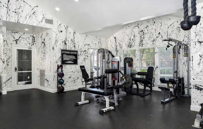 A gym with black and white marble walls and floors.