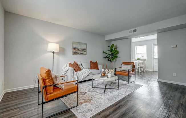 an open living room with couches and chairs and a table
