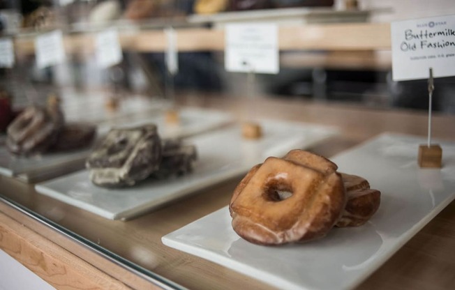 a display case filled with different types of donuts and other desserts