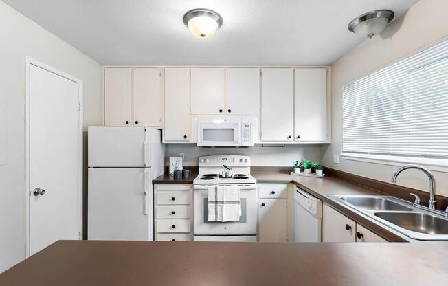 a kitchen with a stove and a refrigerator