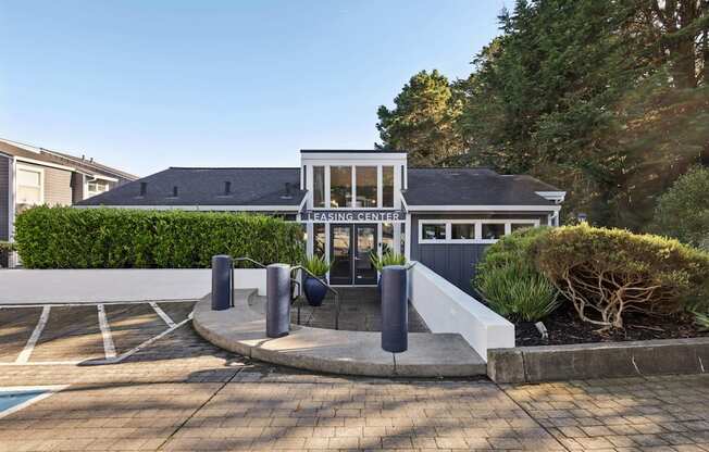 A modern building with a glass entrance and a white awning.
