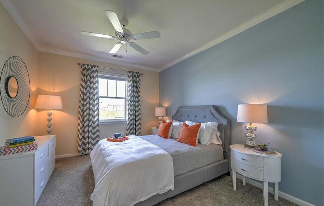 a bedroom with a bed and a ceiling fan