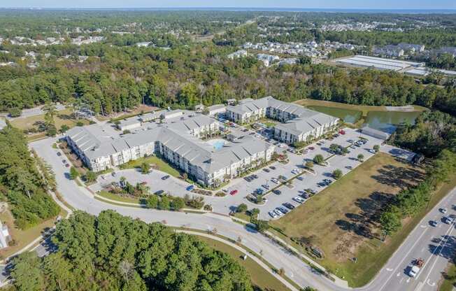 an aerial view of the apartments and parking lot