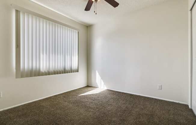 Bedroom With ceiling fan and carpeted flooring