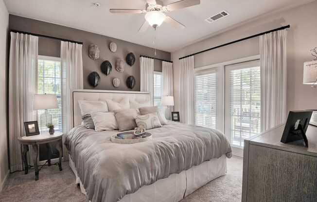 a bedroom with a bed and a ceiling fan