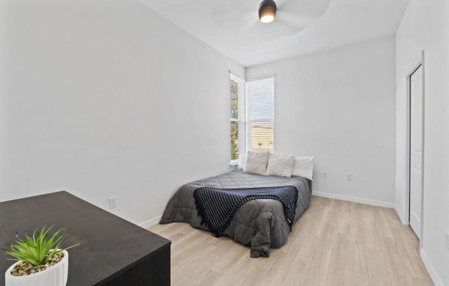 a bedroom with a bed and a large window