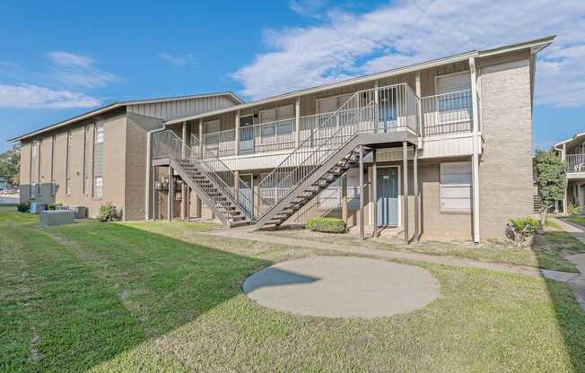A modern apartment building with a staircase leading to the second floor  at The Creole Apartments in Shreveport, LA