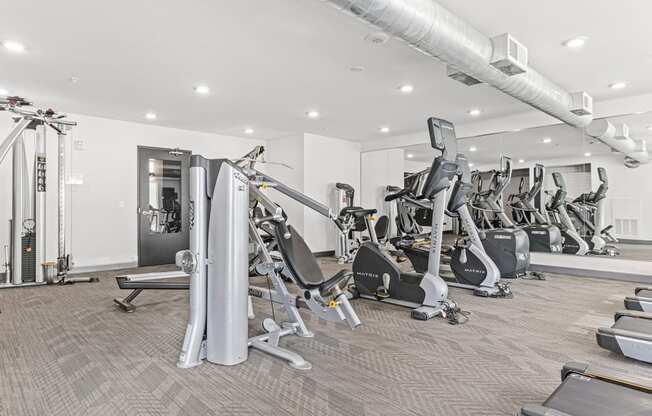 a gym filled with cardio machines and treadmills