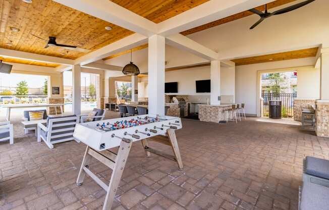 a large covered patio with a foosball table