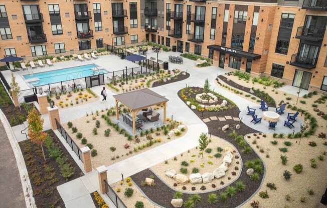 an aerial view of an apartment complex with a pool and patio at The Gallery Apartments, Burnsville, MN