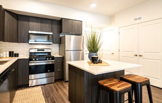 a modern kitchen with stainless steel appliances and black and white