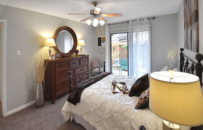 Bedroom with ceiling fan and large window