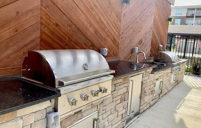 A wall of wood and stone with a grill on top.