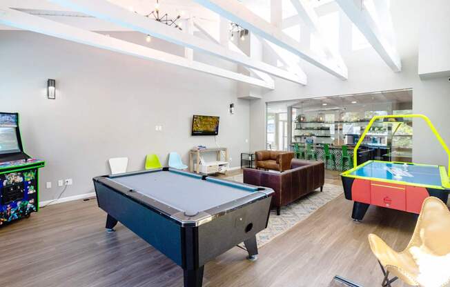 a game room with a pool table and ping pong