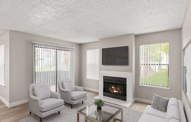 A living room with a fireplace and two chairs.