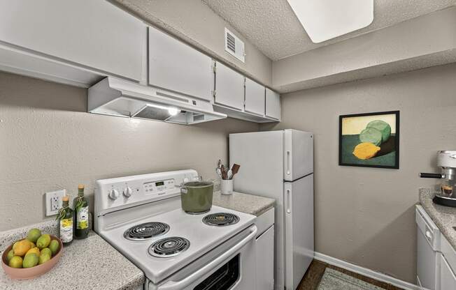 our apartments have a kitchen with white appliances and granite counter tops