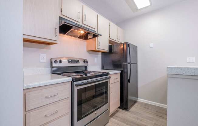 Heathermoor and Bedford Commons kitchen with stainless steel appliances and white cabinets