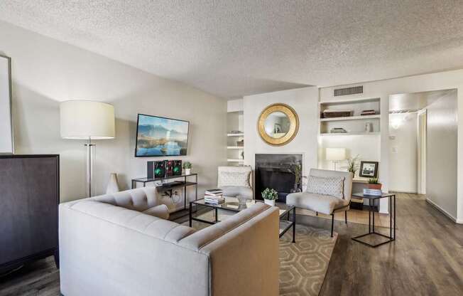 A living room with a fireplace and a painting on the wall.