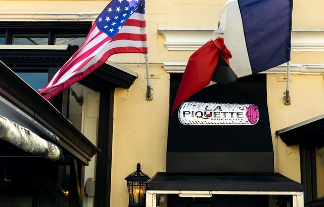 a flag and a sign on the side of a building