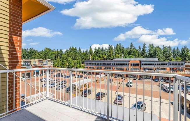A parking lot with cars and a building in the background.