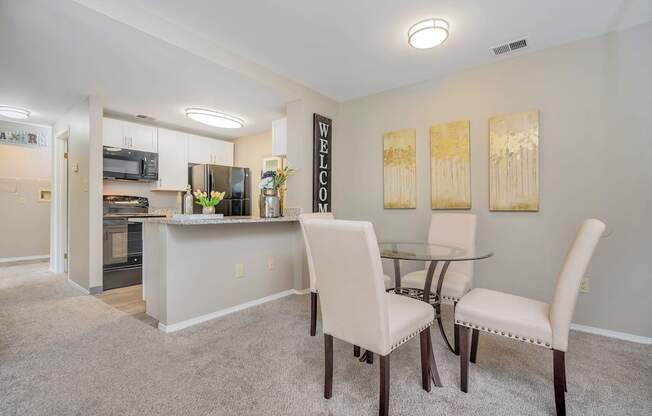 A dining room with a glass table and chairs.