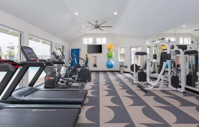 a gym with treadmills and other exercise equipment