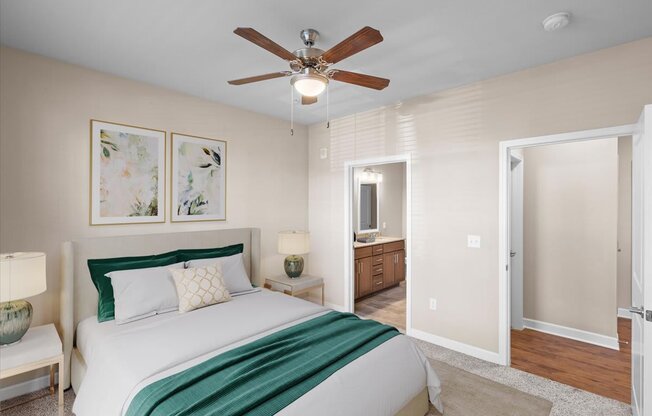 a bedroom with a bed and a ceiling fan