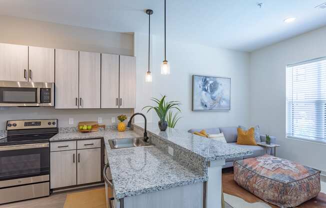a kitchen with granite countertops and stainless steel appliances