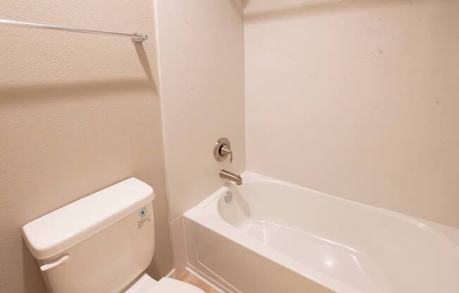 A white toilet and sink in a bathroom.