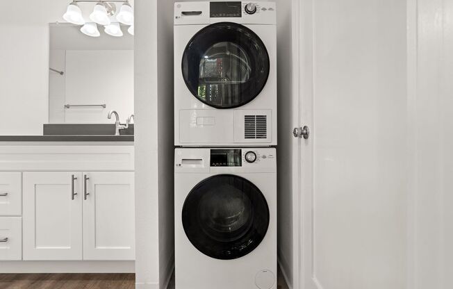 a white washer and dryer in a white kitchen