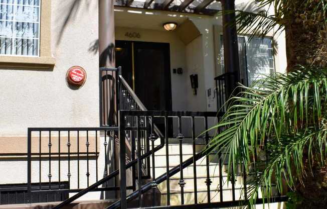 View of exterior entrance to Regency at Sherman Oaks with tropical landscaping