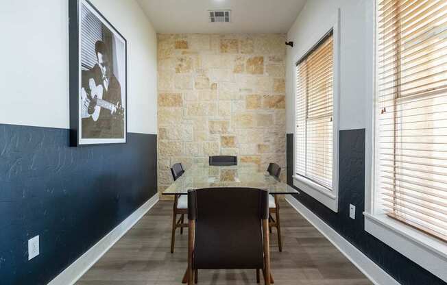 A dining room with a table and chairs.