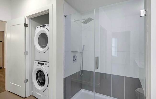 A white laundry room with a washer and dryer in a cabinet.